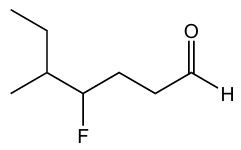 Structural formula of an aldehyde with a fluorine-substituted alkyl chain and a terminal formyl group.