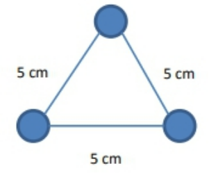 Equilateral triangle with 5 cm sides and a 5 microcoulomb charge at each vertex.