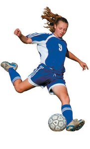 Person kicking a soccer ball, demonstrating muscular system in action