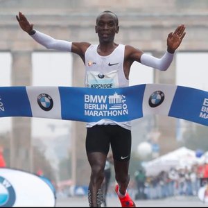 Marathon runner crossing finish line, representing endurance