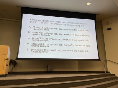 Lecture slide on acetylcholine esterase inhibition and muscle paralysis