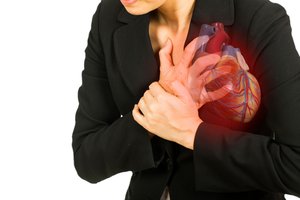 Woman clutching chest, illustrating referred pain