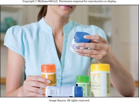 Person examining supplement bottles