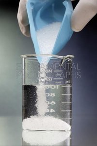Pouring salt into beaker