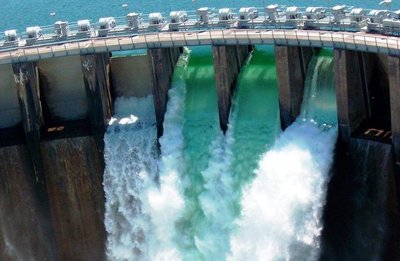 Water flowing over a dam, illustrating potential and kinetic energy
