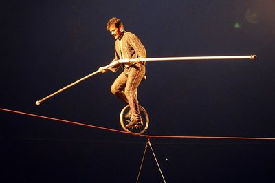 A person balancing on a tightrope, symbolizing the body's effort to maintain homeostasis