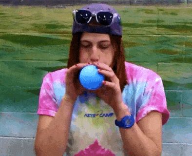 Person inflating a balloon, demonstrating inspiration