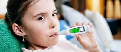 Child measuring body temperature