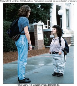 Person with dwarfism compared to average height person