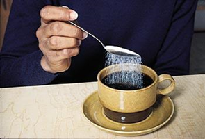 Adding sugar to coffee as an example of a solution