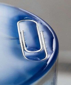 Surface tension demonstrated by a paperclip on water