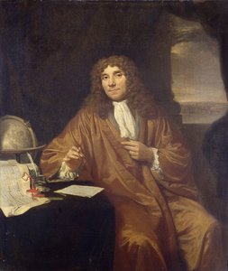 Portrait of Antoni van Leeuwenhoek at a desk with a microscope