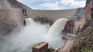 Water gushing through a dam, demonstrating kinetic energy