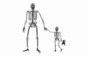 X-ray image of adult and child skeletons holding hands