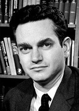 Portrait of a scientist in front of bookshelves