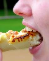 Person biting food, showing oral cavity