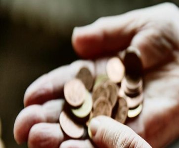 Hand holding coins, representing random outcomes in probability experiments