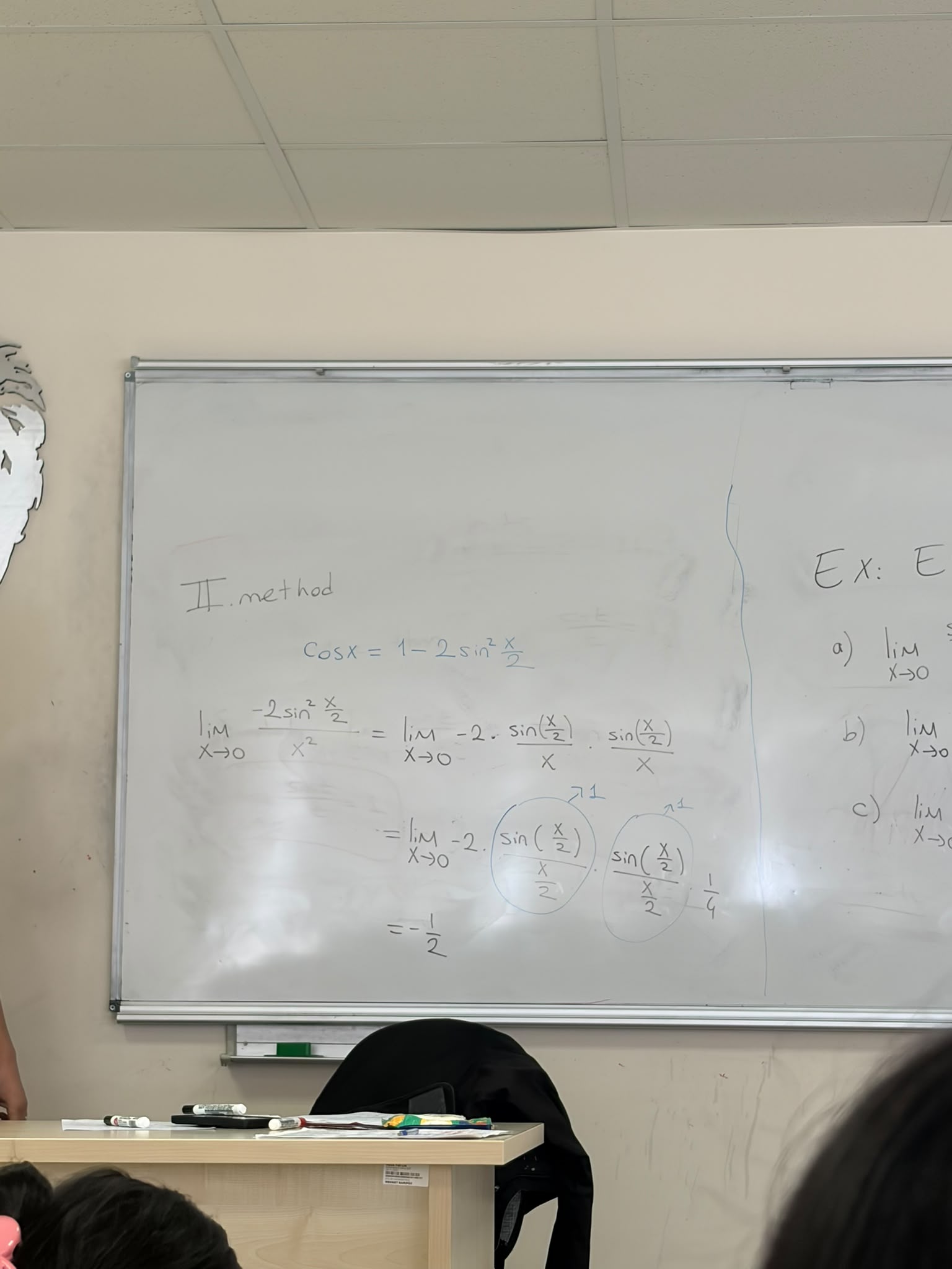 Limit calculation using trigonometric identities and standard limits