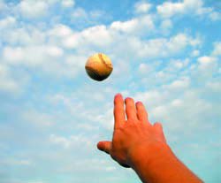 A baseball thrown in the air follows a continuous trajectory, illustrating the concept of continuity in motion.