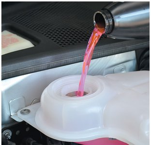 Antifreeze being poured into a car