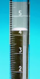 Meniscus in a glass tube, illustrating capillary action and the balance of cohesive and adhesive forces.