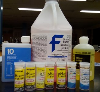 Various buffer solutions and pH standards used in laboratory settings