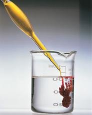 Precipitate formation in a beaker, illustrating a chemical reaction