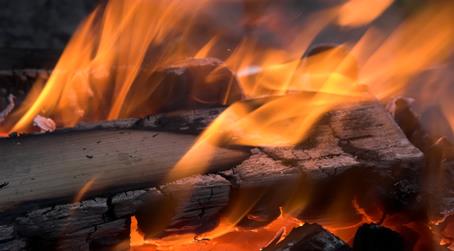 Wood burning with flames, illustrating heat and light as evidence of a chemical reaction