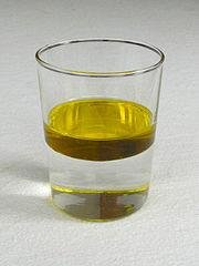 Oil floating on water due to lower density