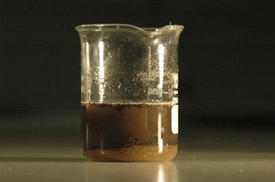 Suspension of sand in water, showing settling of particles