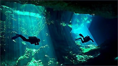 Divers in an underground river system