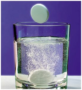 Antacid tablet fizzing in water