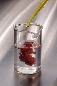 Addition of a reagent to a solution causing precipitation