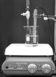 Laboratory setup for acid-base titration with pH meter and stirrer