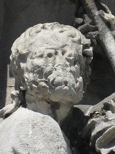 Weathered stone statue, showing acid rain damage