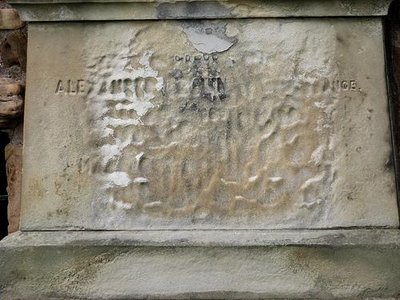 Eroded gravestone, illustrating acid rain's effect on limestone