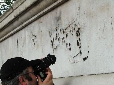 Wall with pitted surface, showing acid rain corrosion