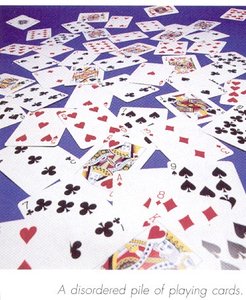 A disordered pile of playing cards, illustrating entropy as disorder