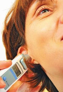 Digital ear thermometer measuring temperature