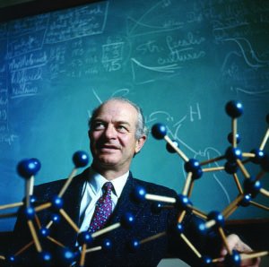 Chemist with molecular model and chalkboard