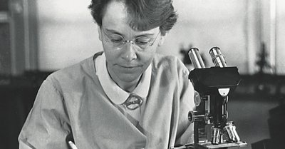 Scientist at microscope, representing Barbara McClintock