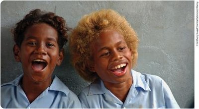 Two individuals from the Solomon Islands, one with dark hair and one with blond hair