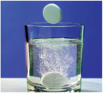 Antacid tablet undergoing a chemical reaction in water