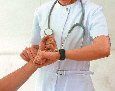 Nurse measuring pulse with a stopwatch