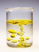 Oil and water in a beaker, representing a heterogeneous mixture