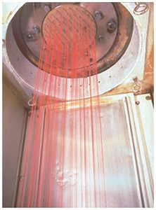 Synthetic polymer fibers being spun