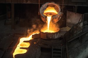 Molten metal being poured, illustrating a physical change (melting)