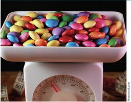Candies being weighed on a scale, illustrating counting by mass