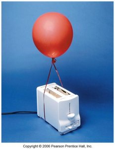 Hot air balloon rising due to lower density
