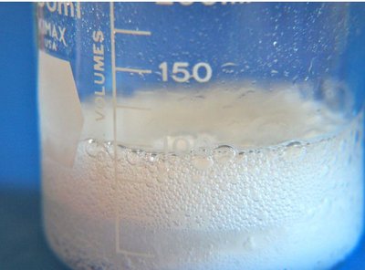 Beaker showing signs of a chemical reaction